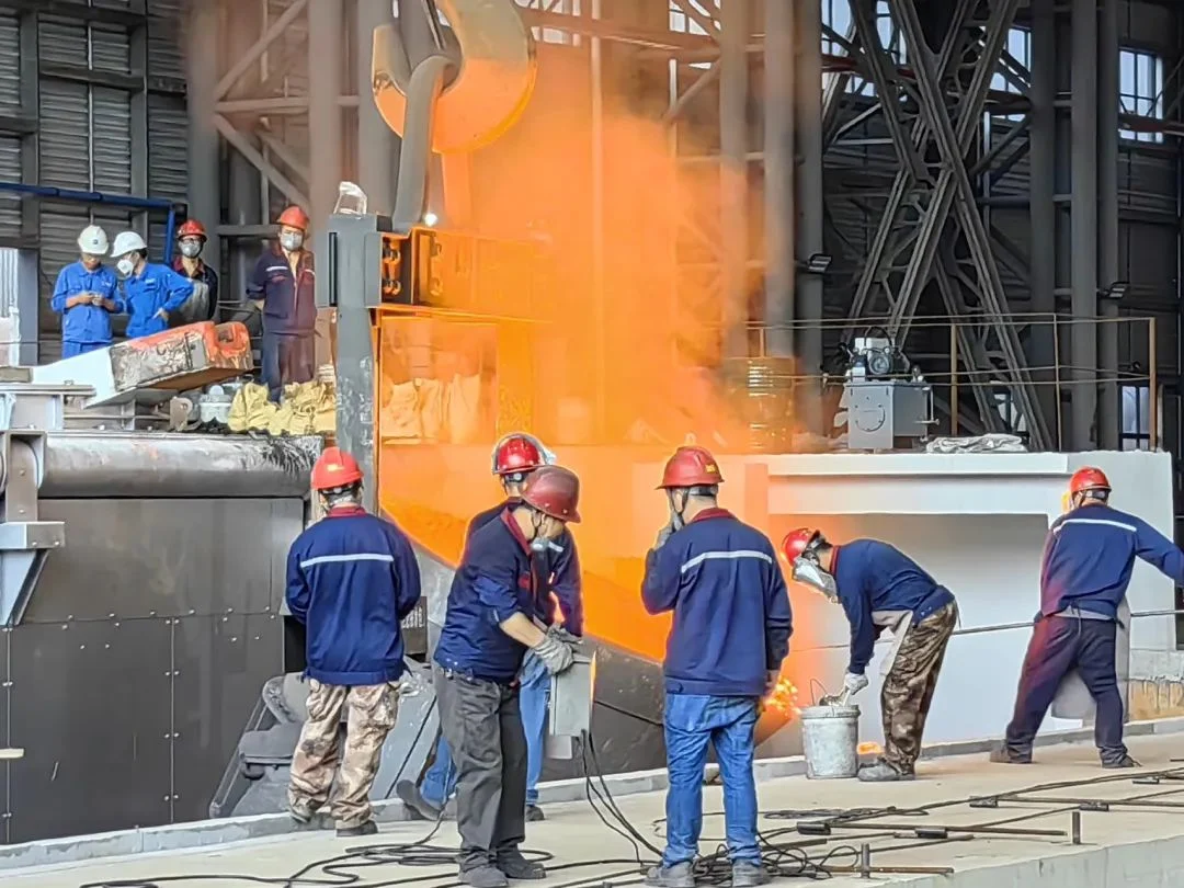 Foundry crane handling hot metal equipment in a workshop