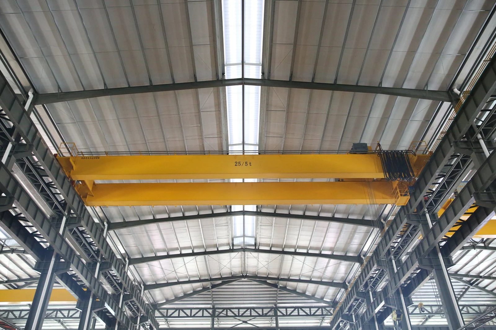 Double girder overhead crane positioned above the production area