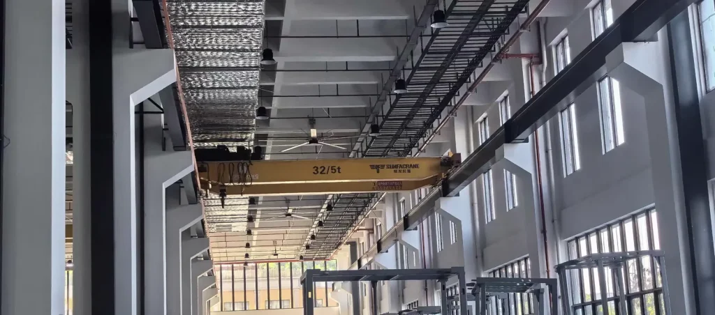 32/5t overhead crane serving a heavy equipment assembly bay